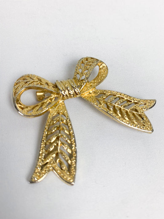 Broche nœud en métal doré vintage